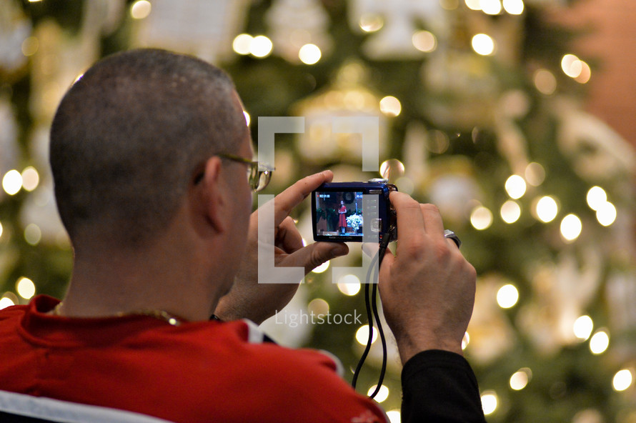 Father photographing his daughter at a Christmas program at Union Chapel United Methodist Church, Albemarle, North Carolina, December, 2013