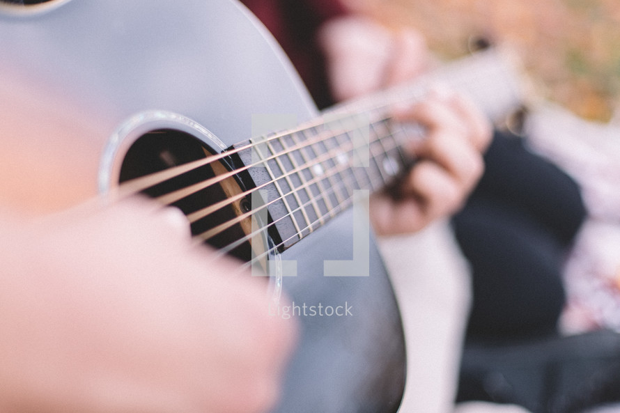 a man strumming a guitar 