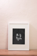chalk words He is Risen in a frame