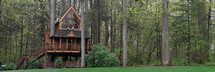 Large treehouse in a forest.