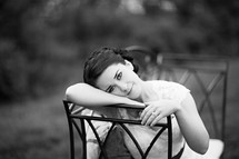 a bridal portrait - bride sitting in a chair outdoors 