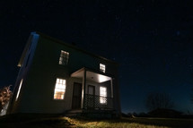 White farm house at night