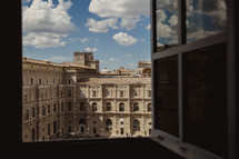 view out a window of buildings in Rome 