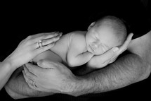 hands holding a newborn baby