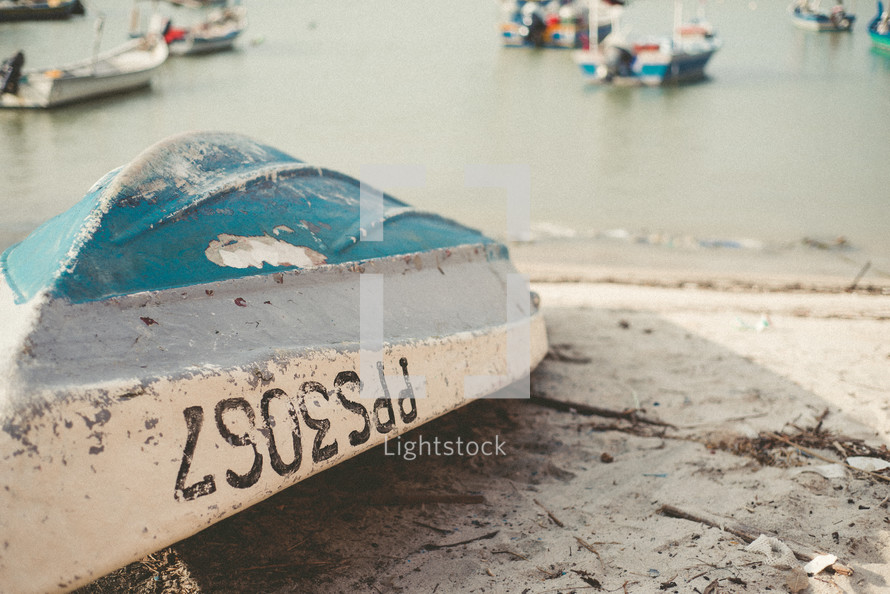overturned boat on a beach 