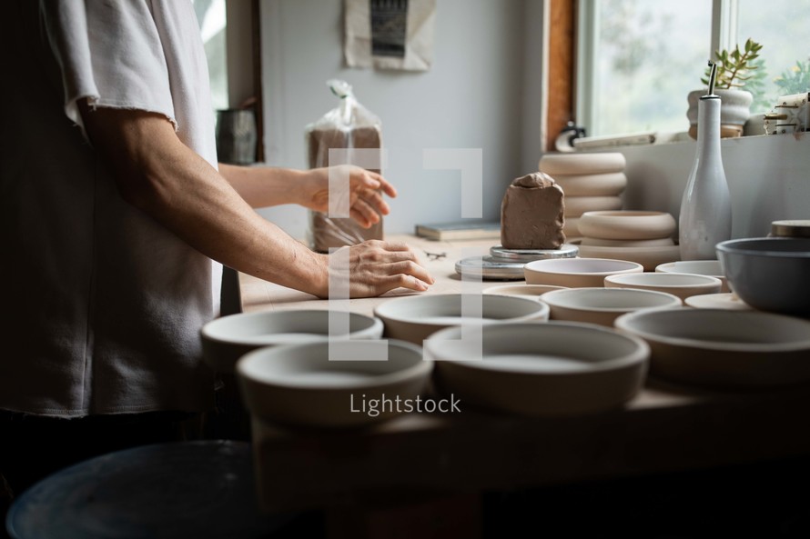 potter making bowls 