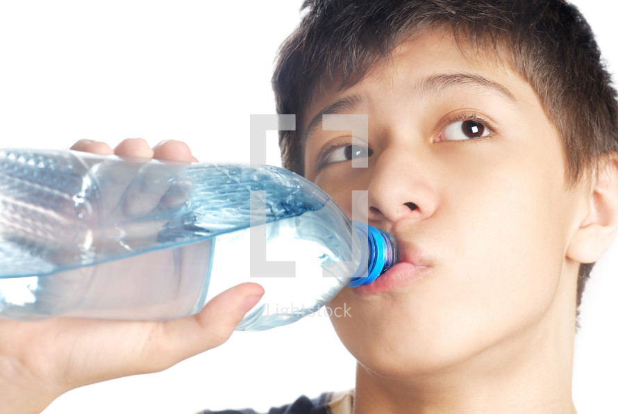 a boy drinking a bottle of water 