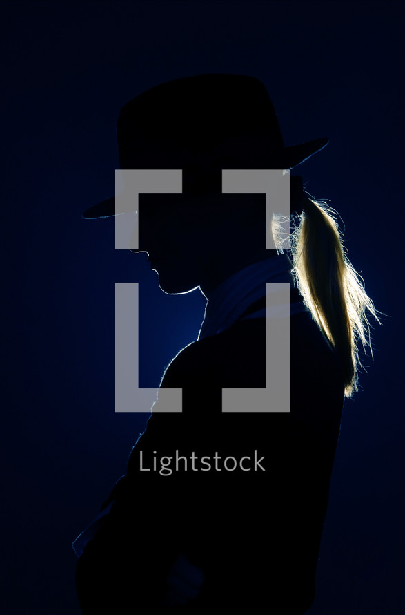 Side-view photo of the woman silhouette with hat