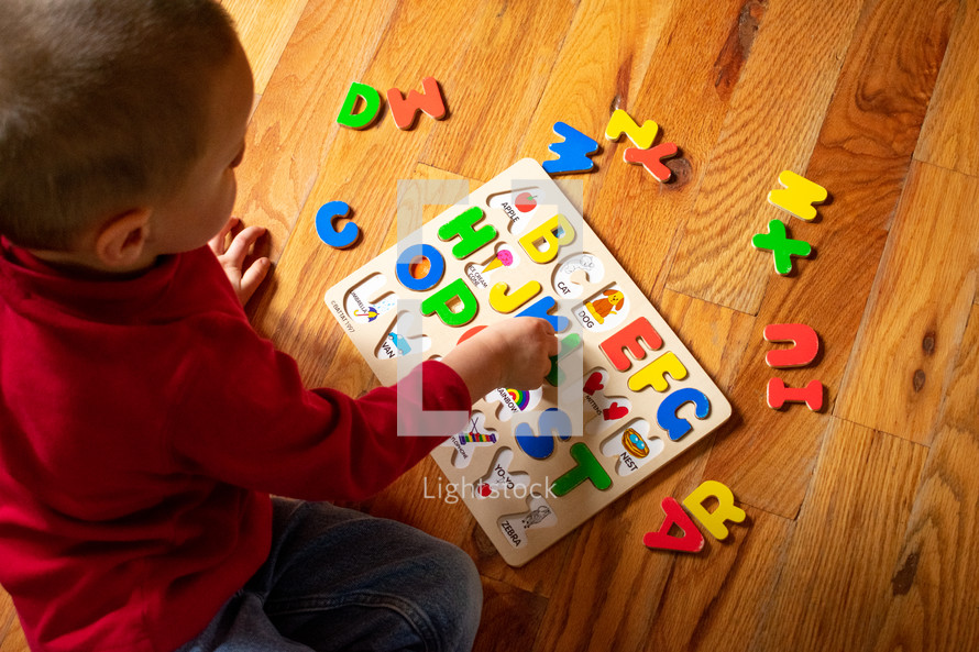 a toddler playing with a puzzle 
