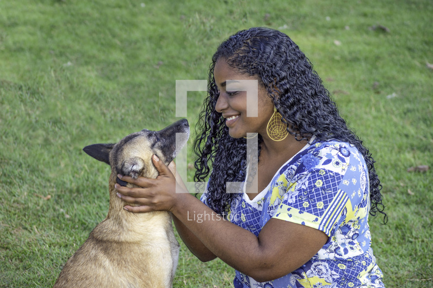 a woman petting a dog 