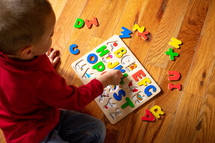 a toddler playing with a puzzle 