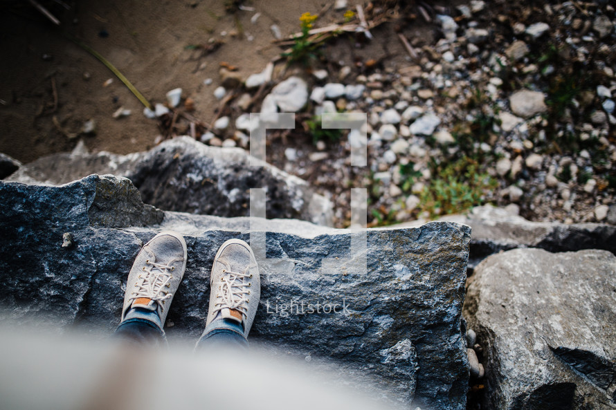 feet of child standing on a rock 