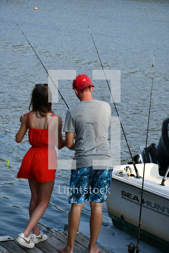 brother and sister fishing on a dock