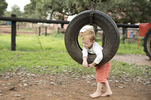 child in a tire swing 