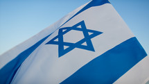 Flag of Israel on blue sky