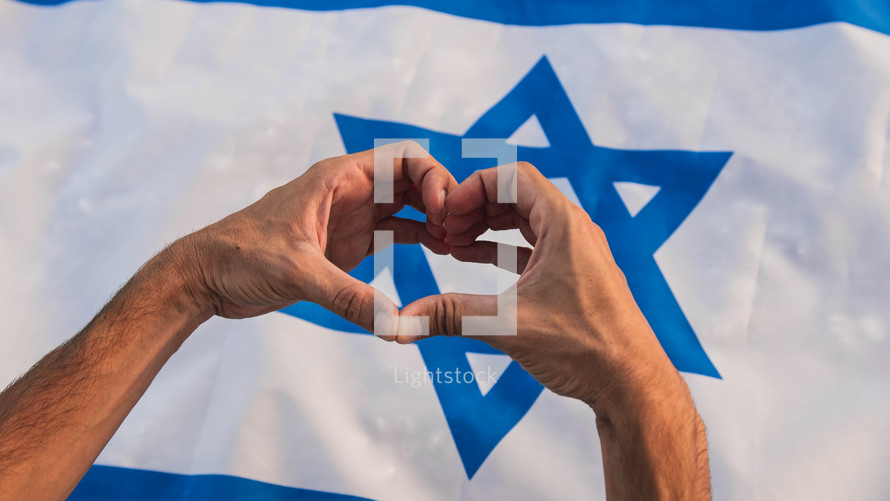 Hand in heart shape on Israel flag