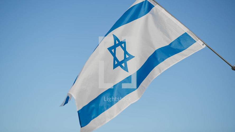 Flag of Israel on blue sky