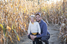 Dad and daughter in corn stalks