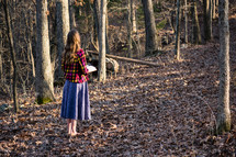 a girl standing outdoors reading a Bible 