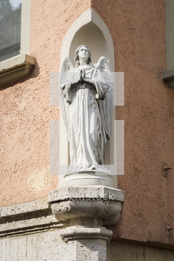 angel statue at the corner of a building 