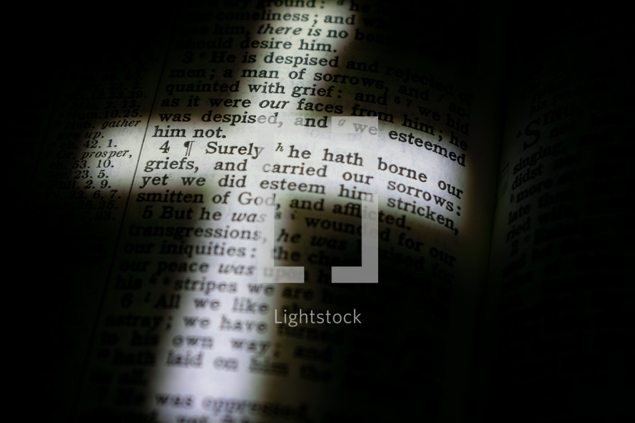 illuminated cross on the pages of a Bible 