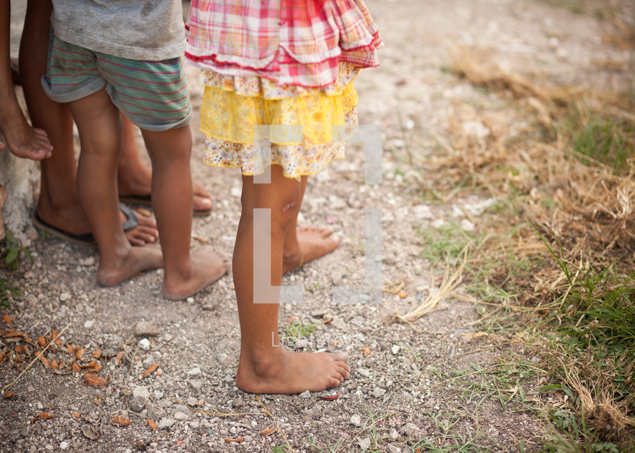children's bare feet on gravel 