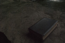 Bible lying on a rock
