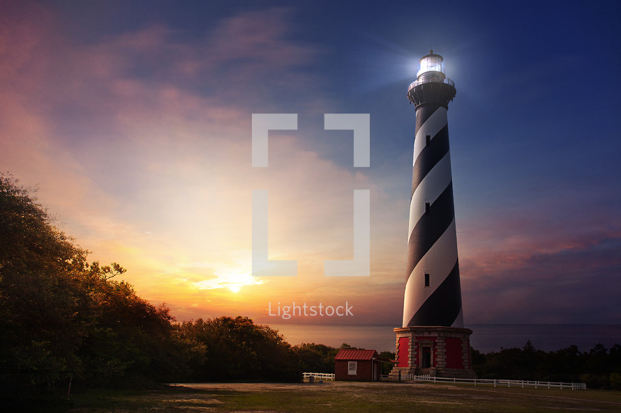 white and black lighthouse at sunset 