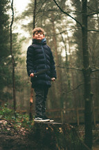 a boy in a forest 