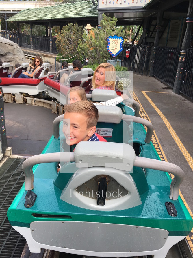a family on a rollercoaster at Disneyland 