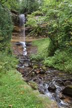 waterfall and stream in a forest 