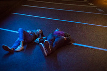 couple lying in a parking space 