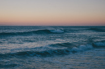 a wave breaking at dawn