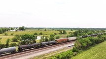 Panning down on freight train cars in the country creates a parallax effect.