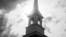 steeple against clouds - black and white