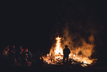 people standing around a bon fire 