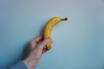 hand holding a banana for dessert