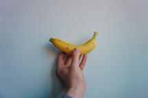hand holding a banana for dessert