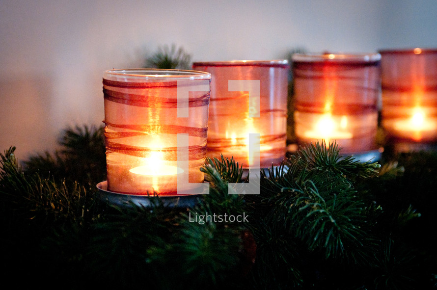 A Christmas centerpiece with candles. 