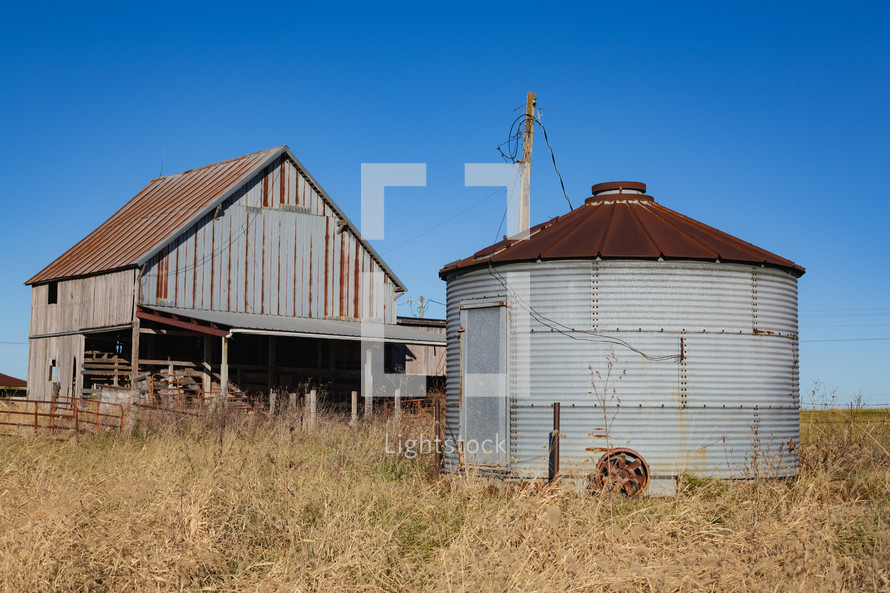 Rusty silo and metal barn