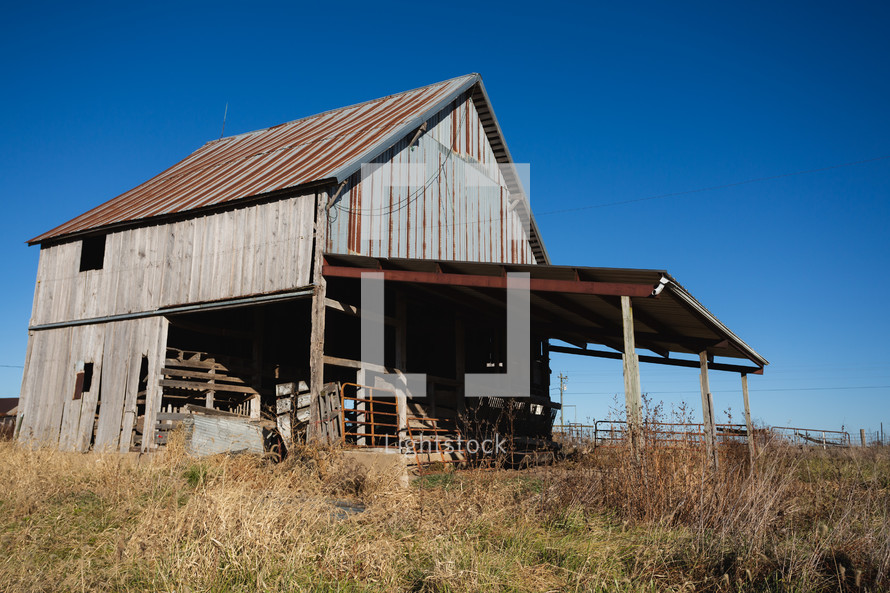 Wood building with rusted roof in rural area