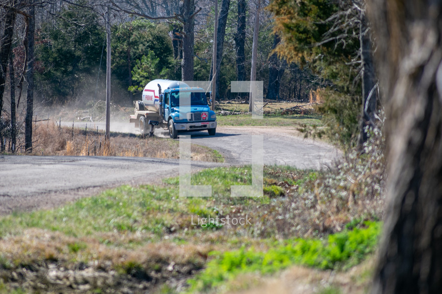 propane truck on a dirt road 