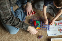 father and son building a circuit 
