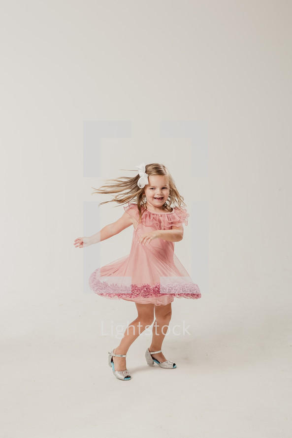 little girl dancing in a dress 