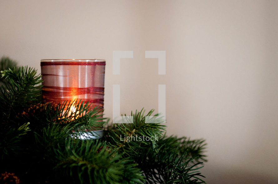 A Christmas centerpiece and candle. 