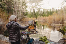 an artist painting a nature scene 