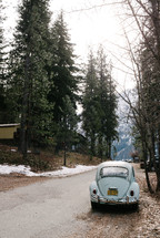 Volkswagen Beetle parked on a mountain road 