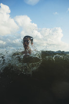 teen boy swimming in the ocean 