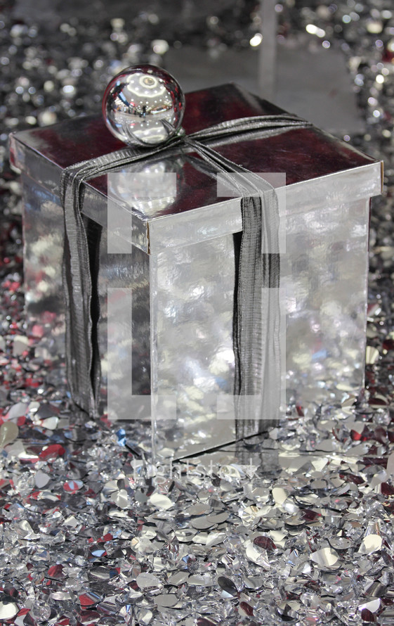 A silver gift in shiny silver confetti.