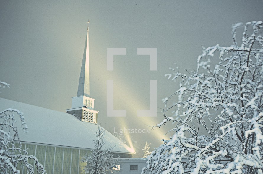 spotlights on a church in snow 